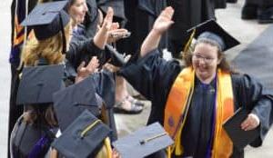 female grad giving high five